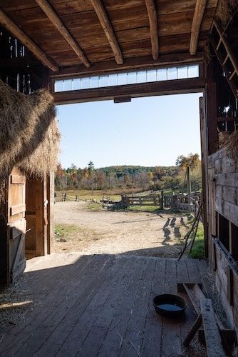 Looking out of a barn onto a dirt path