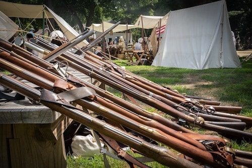 Muskets at the ready at a reenactment at the museum