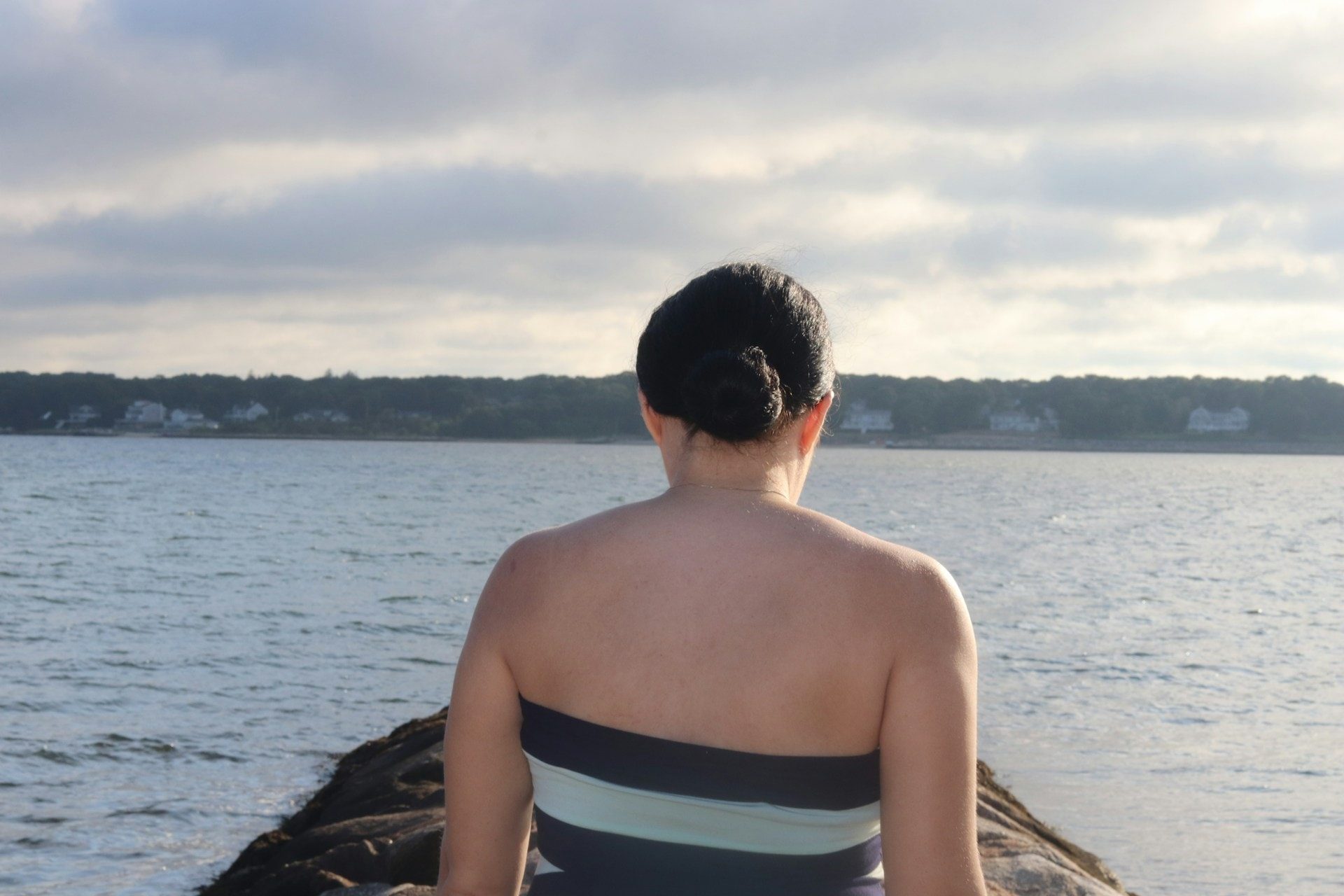 Woman on a jetty at West Beach in New Bedford Massachusetts