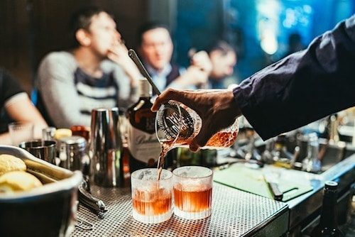 Bartender pouring a high quality cocktail while music plays at one of the best cocktail bars in Greenwich CT