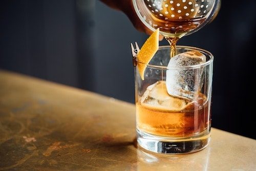 Pouring a mixed drink close to the NY border