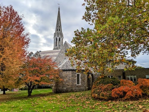 Fall foliage in New England amidst an impressive church