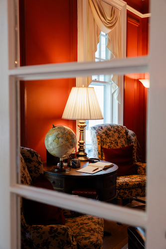 Reflection of the library in a mirrored door at a great inn