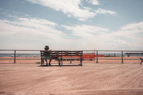 Woman occupying a prime location on the Asbury Park boardwalk, one of the best getaways from NYC