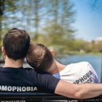 Couple taking a break on a bench while they explore gay Connecticut