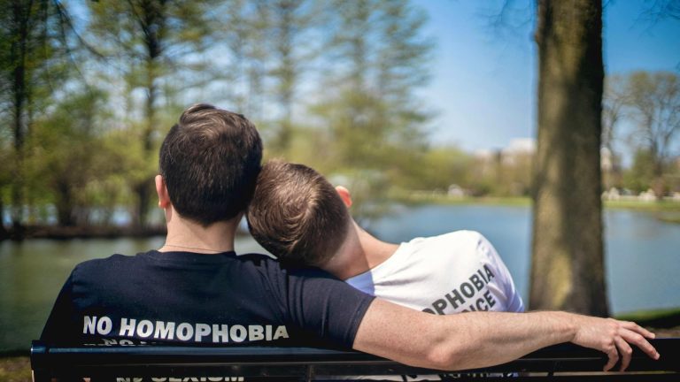 Couple taking a break on a bench while they explore gay Connecticut