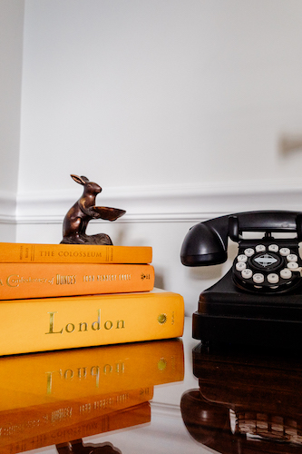 Old knick knacks, books, and the phone in Room 18