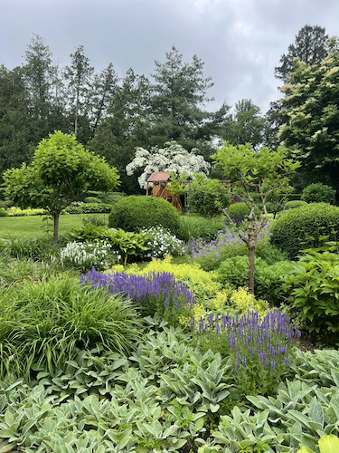 A playset amidst a gorgeous garden on a Greenwich estate