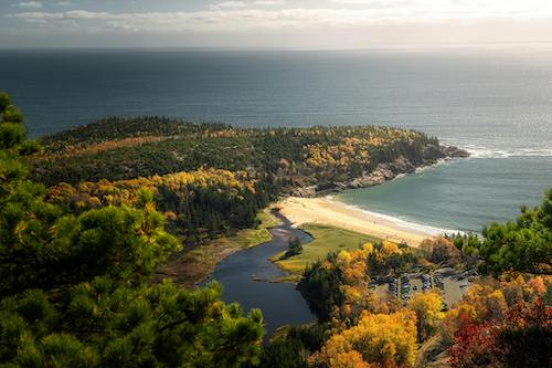View of Sand Beach in fall from the precipice of the Beehive Trail in Acadia National Park