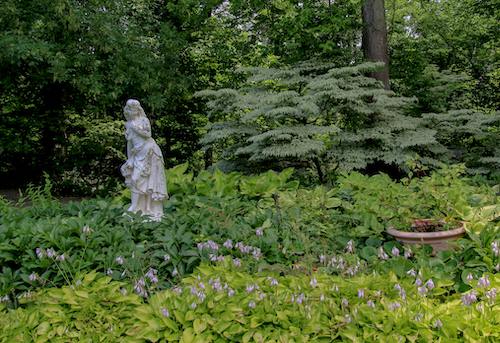 A statue in a charming estate garden