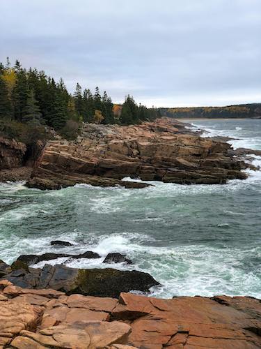 Waves crashing against the shore of Acadia National Park